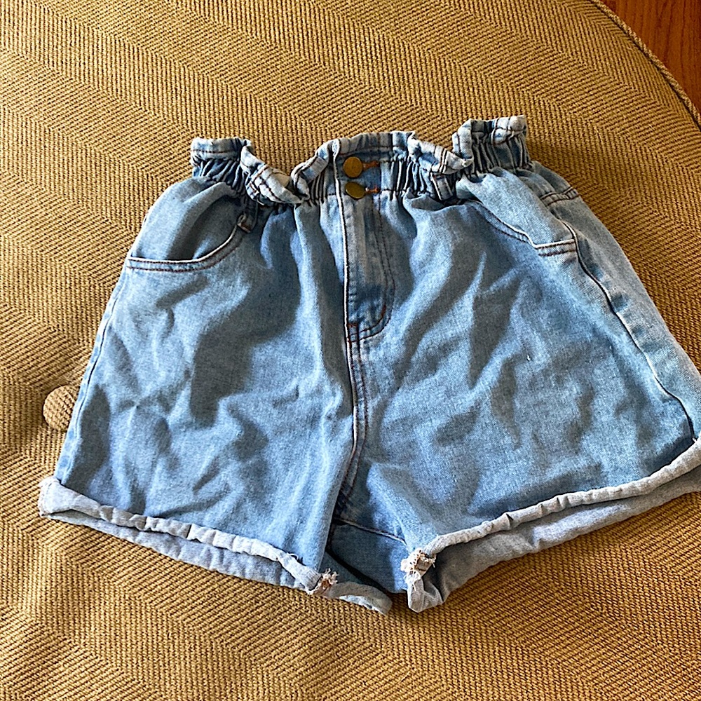 Blue stretchy waist shorts with gold buttons and pockets